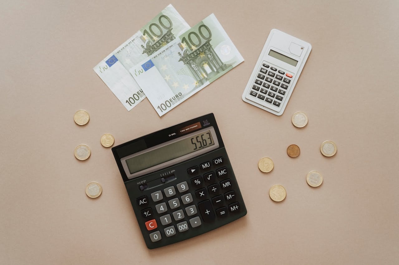 Flat lay of calculators and Euro currency, depicting financial calculations and budget management.
