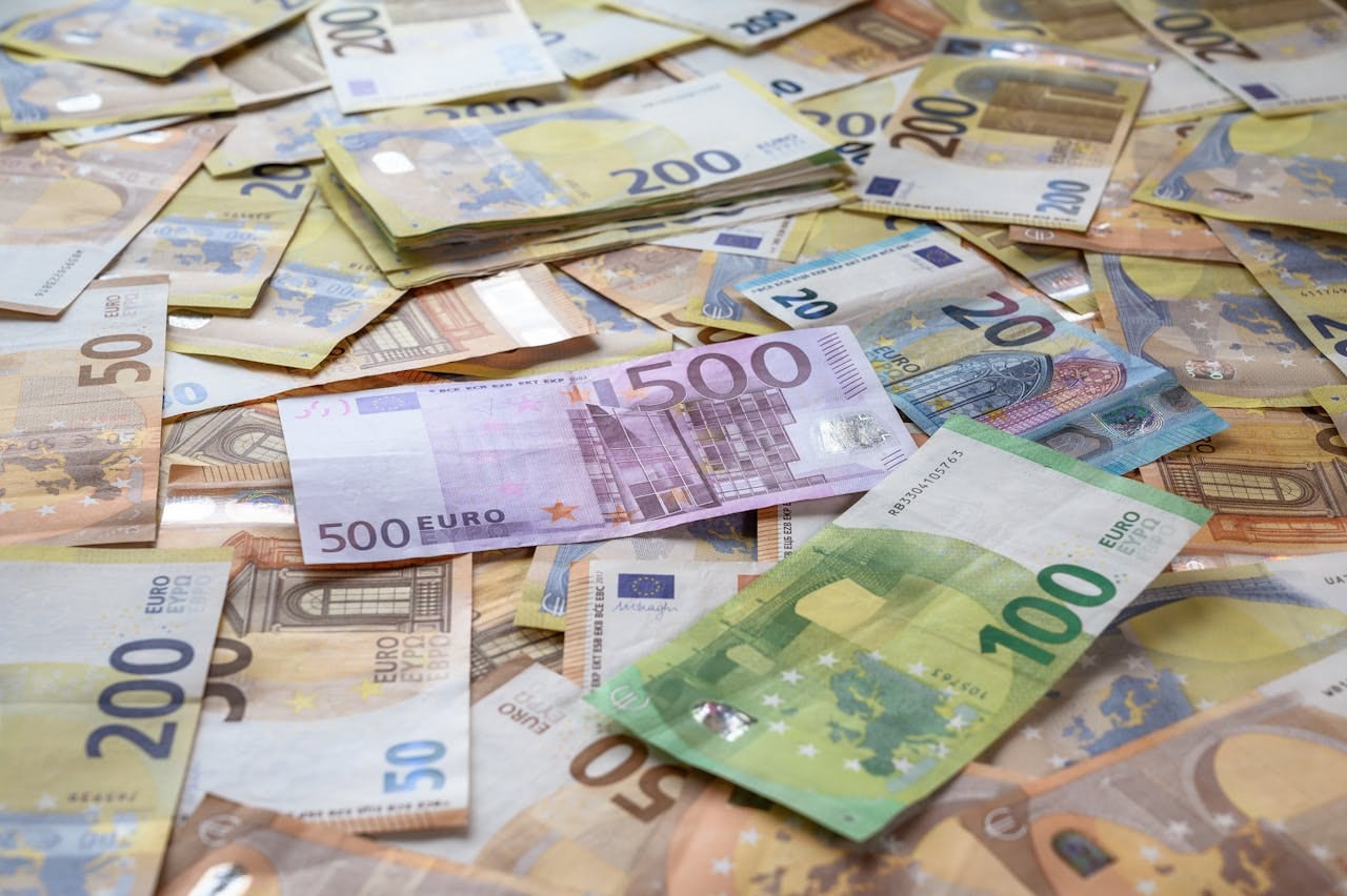 A collection of Euro banknotes representing wealth, savings, and European economy.